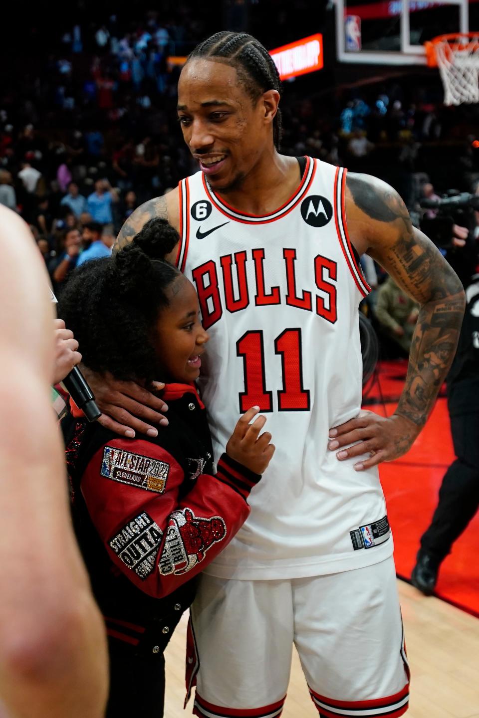 DeMar DeRozan gets a hug from his daughter after the Chicago Bulls' victory over the Toronto Raptors.