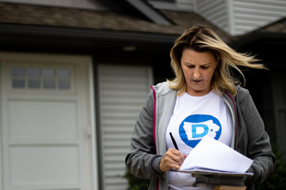 Amy Nielsen, D-North Liberty, takes notes while door knocking, Saturday, Sept. 24, 2022 in Iowa City, Iowa.