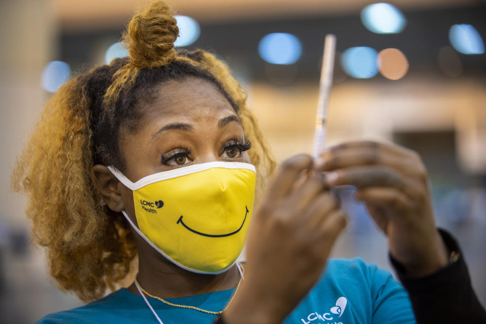 FILE - Medical Assistant Keona Shepard holds up the Johnson & Johnson COVID-19 vaccine as she prepares to administer it at the New Orleans Ernest N. Morial Convention Center during the mass coronavirus vaccination in New Orleans, in this Thursday, March 4, 2021, file photo. (Chris Granger/The Advocate via AP, File)