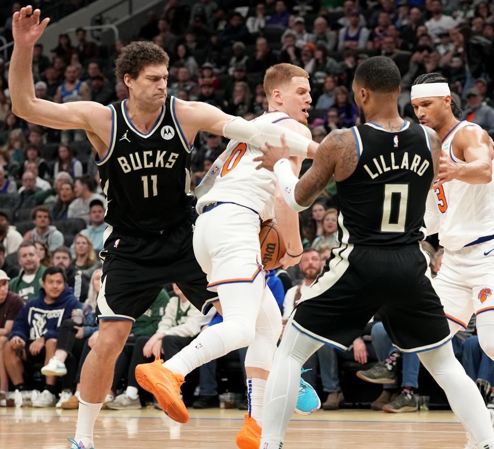 Knicks guard Donte DiVincenzo is swarmed by Bucks center Brook Lopez (11) and guard Damian Lillard during the first half Sunday at Fiserv Forum. 



Mark Hoffman/Milwaukee Journal Sentinel