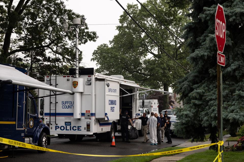 Crime laboratory officers are seen outside the home of Gilgo Beach murders suspect Rex Heuermann in Massapequa Park, New York, on July 18, 2023.