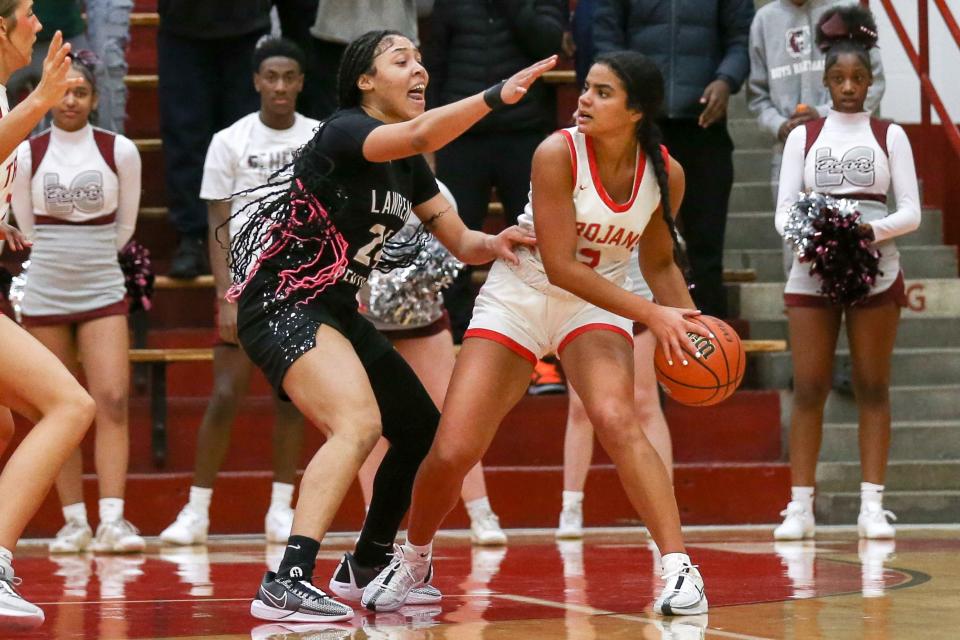 Center Grove Aubrie Booker (3) ) looks for an open teammate for a pass while guarded by Lawrence Central Aniyah Mckenzie (24) as Lawrence Central takes on Center Grove High School in the Girls Class 4A IHSAA Southport Semi-state basketball championship, Feb 17, 2024; Indianapolis, IN, USA; at Southport High School