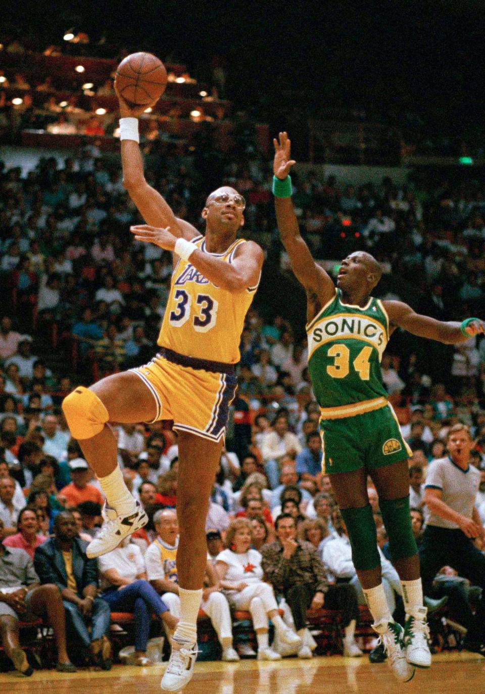 Los Angeles Lakers' Kareem Abdul-Jabbar goes up on a sky hook against Seattle Sonics' Xavier McDaniel in 1989.