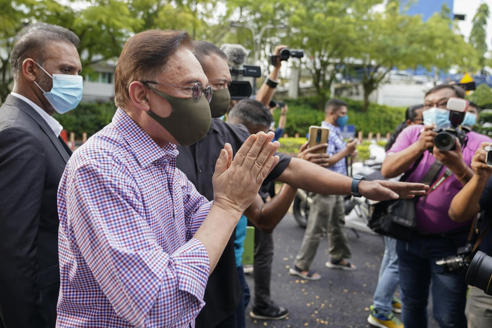 Malaysian opposition leader Anwar Ibrahim gestures after speaking to media outside police headquarters in Kuala Lumpur, Malaysia, Friday, Oct. 16, 2020. Anwar was questioned by police over the dissemination of a purported list of lawmakers supporting his bid to oust the government. (AP Photo/Vincent Thian)