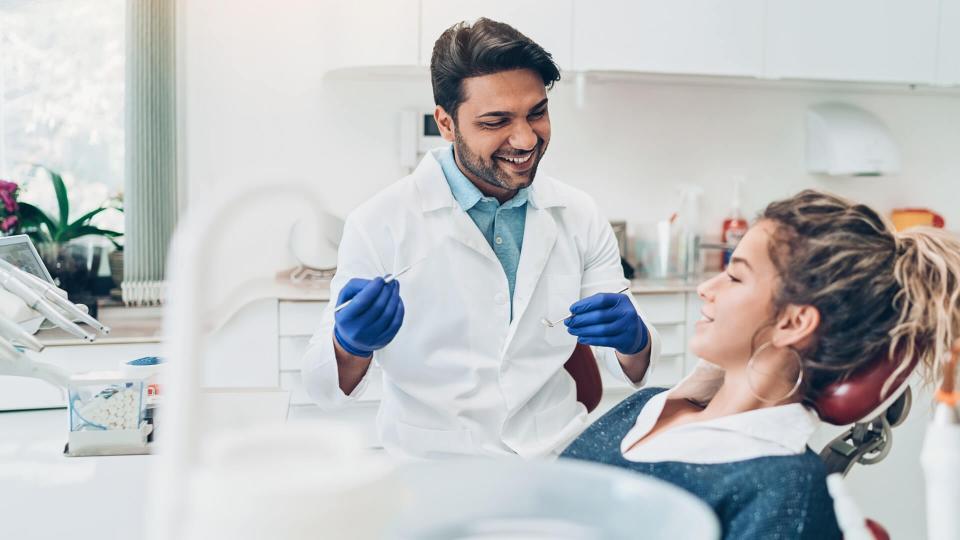 Dentist and female patient in the dentist's office.