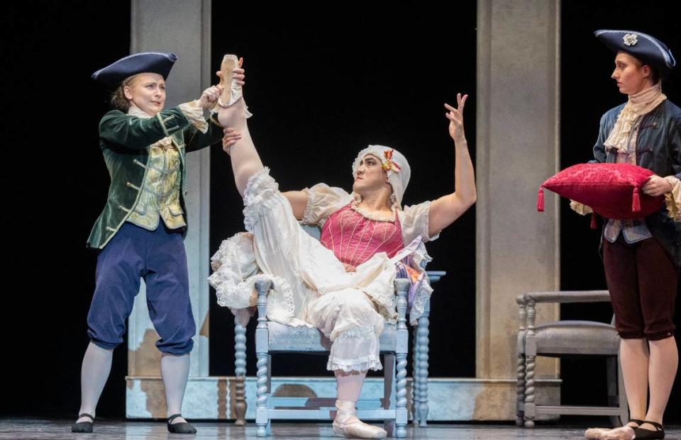 Eugene Obille, center, playing an evil step sister, tries to force the missing ballet slipper to fit during a Sacramento Ballet dress rehearsal of Cinderella on Thursday, Feb. 15, 2024. Lezlie Sterling/lsterling@sacbee.com