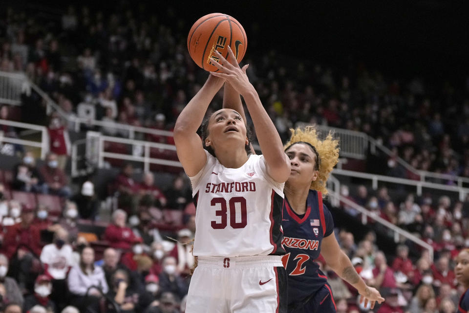 Stanford guard Haley Jones (30) drives to the basket against Arizona forward Esmery Martinez (12) during the second half of an NCAA college basketball game Monday, Jan. 2, 2023, in Stanford, Calif. (AP Photo/Tony Avelar)