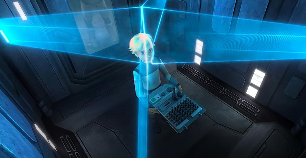  A person with short blond hair stands in an elevator-like room while being scanned with blue laser lights. 