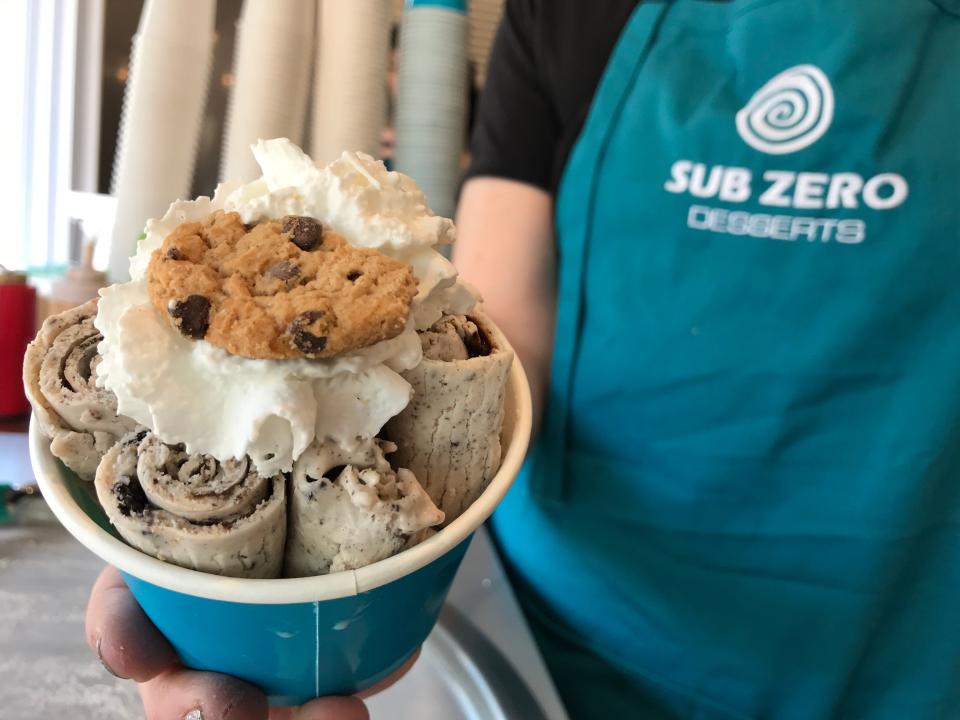 Jessica Rooney holds up the "Cookie Monster," one of the menu items at Dakota Snow/Sub Zero Desserts in June 2019.