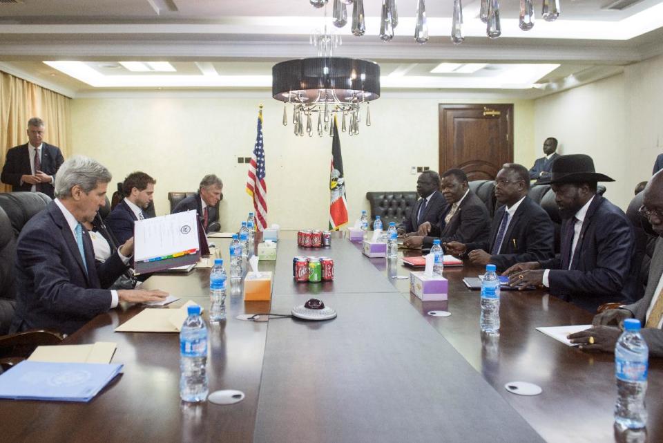 U.S. Secretary of State John Kerry, left, meets with South Sudan's President Salva Kiir, second right wearing a hat, at the President's Office in Juba, South Sudan, Friday, May 2, 2014. Kerry is urging South Sudan's warring government and rebel leaders to uphold a monthslong promise to embrace a cease-fire or risk the specter of genocide through continued ethnic killings. (AP Photo/Saul Loeb, Pool)