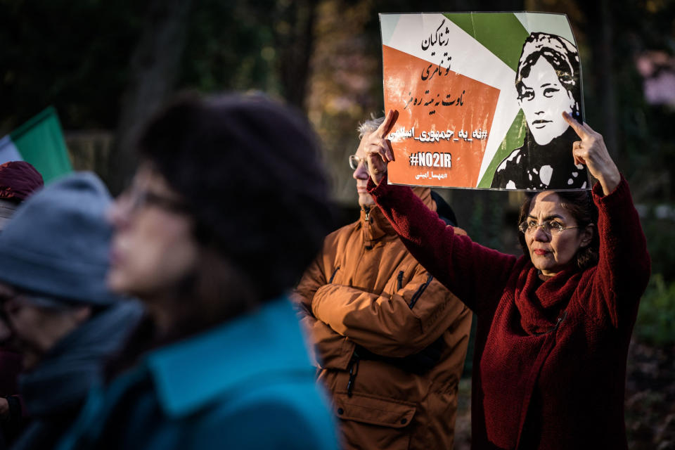 <p>A woman raises a poster during a demonstration in front of the House of Representatives in The Hague, Netherlands, on Dec. 7.</p>