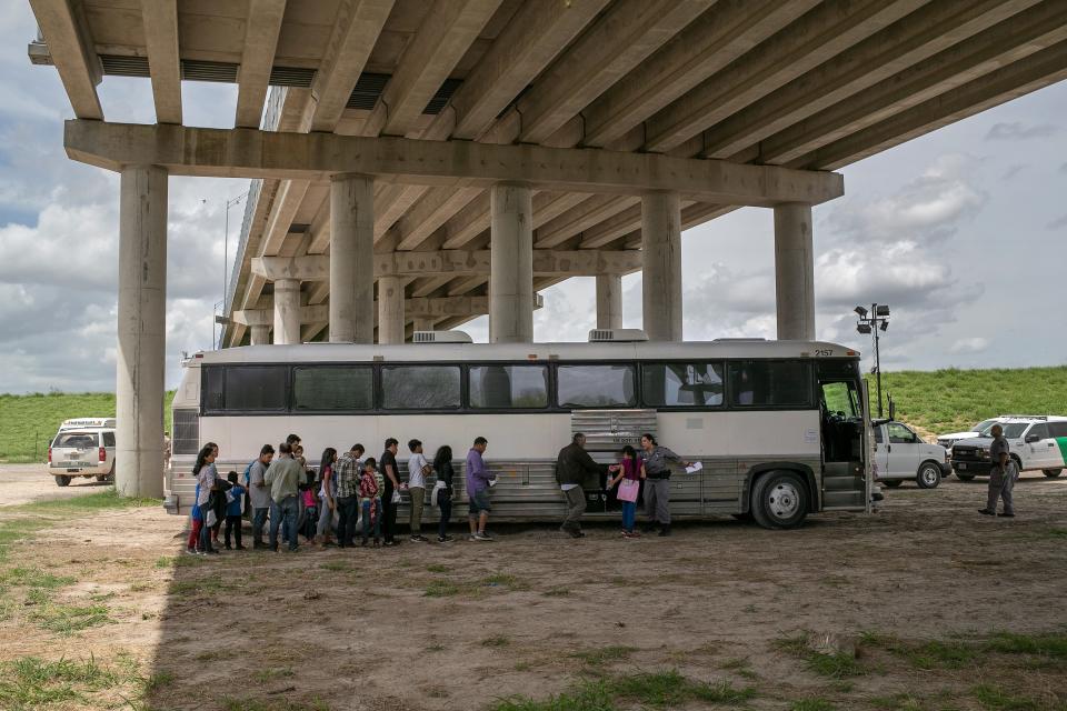 Immigrants wait to be transported to a U.S. Border Patrol processing center after they were taken into custody on July 02, 2019 in McAllen, Texas. The immigrants, mostly families from Central America, turned themselves in to border agents after rafting across the Rio Grande from Mexico to seek political asylum in the United States.