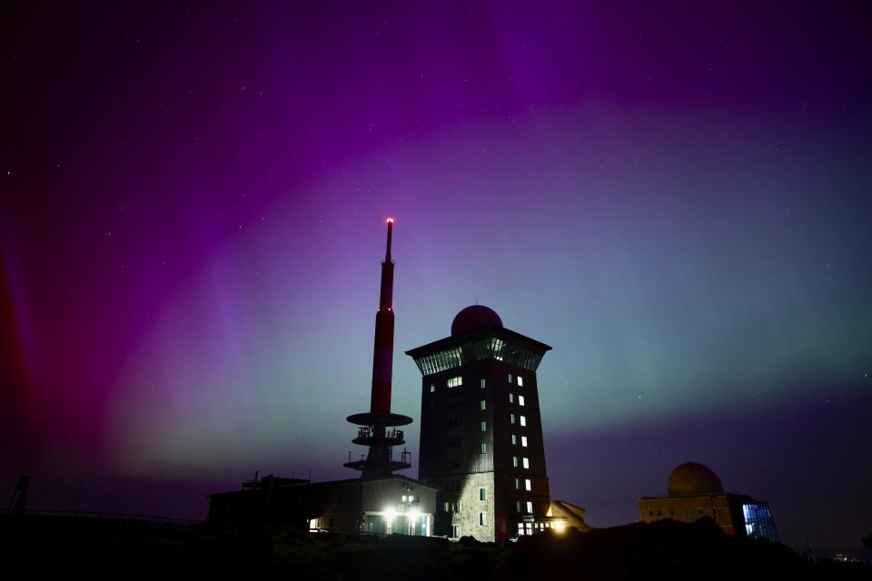 Northern lights appear in the night sky above the Brocken early Saturday, May 11, 2024, in Schierke, northern Germany. Brilliant purple, green, yellow and pink hues of the Northern Lights were reported worldwide, with sightings in Germany, Switzerland, London, and the United States and Canada. (Matthias Bein/dpa via AP)