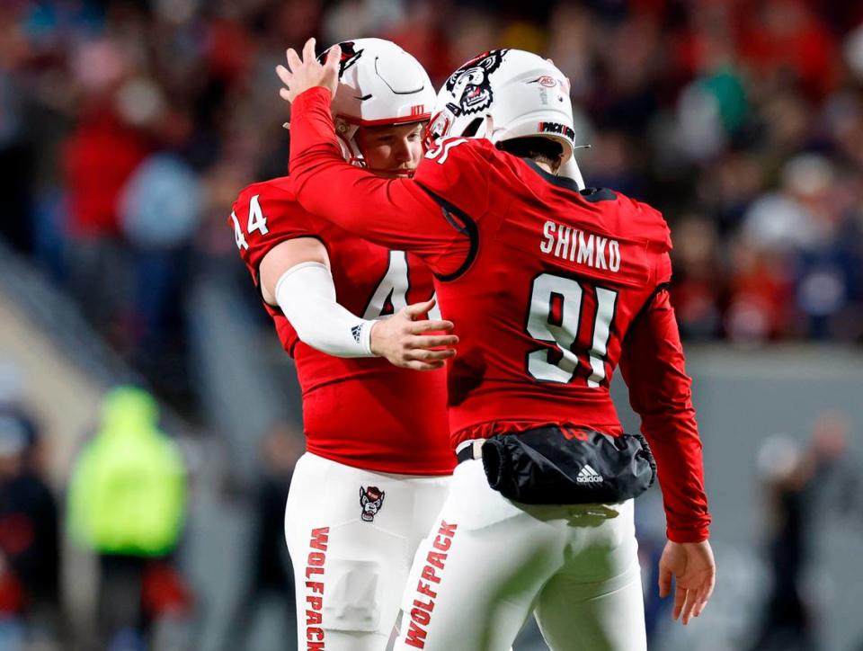 N.C. State long snapper Joe Shimko (91) congratulates kicker Brayden Narveson (44) after Narveson kicked a 32-yard field during the first half of N.C. State’s game against UNC at Carter-Finley Stadium in Raleigh, N.C., Saturday, Nov. 25, 2023.