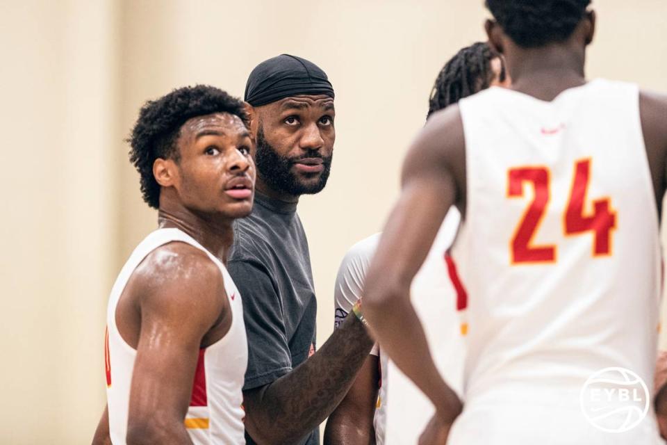 LeBron James talks with son Bronny James during a Nike basketball event in July 2021. LeBron has expressed a desire to play in the NBA at the same time as Bronny.