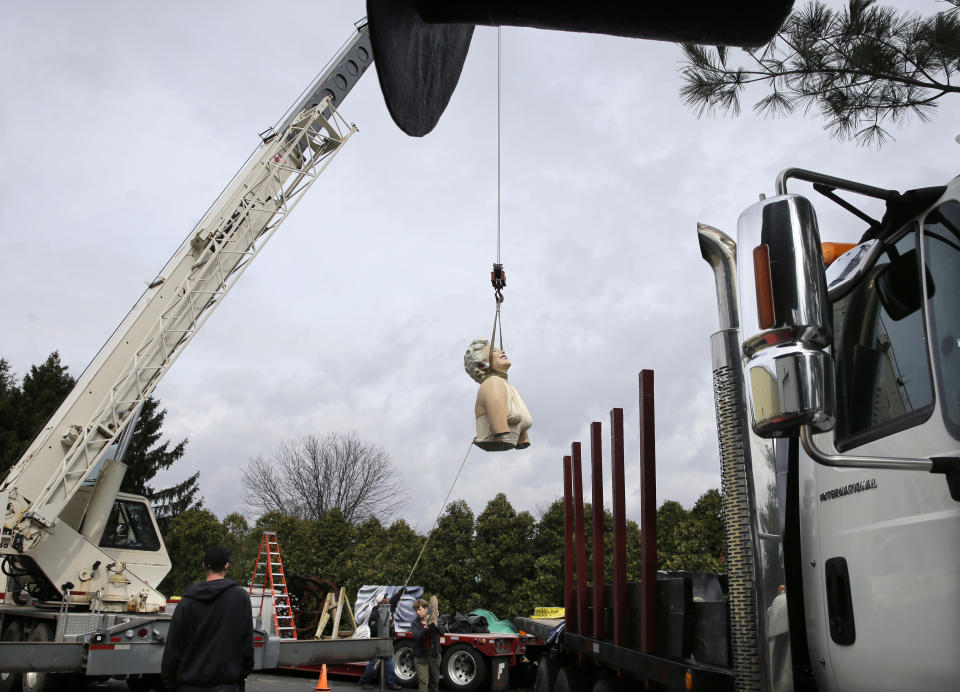 A crane lifts the torso of a 26-foot-tall, 34,000-pound statue named "Forever Marilyn" in Hamilton, N.J., Tuesday, April 8, 2014. The sculpture depicting Marilyn Monroe in her memorable billowing skirt pose from the "The Seven Year Itch" is part of an exhibit honoring its designer, Seward Johnson. (AP Photo/Mel Evans)