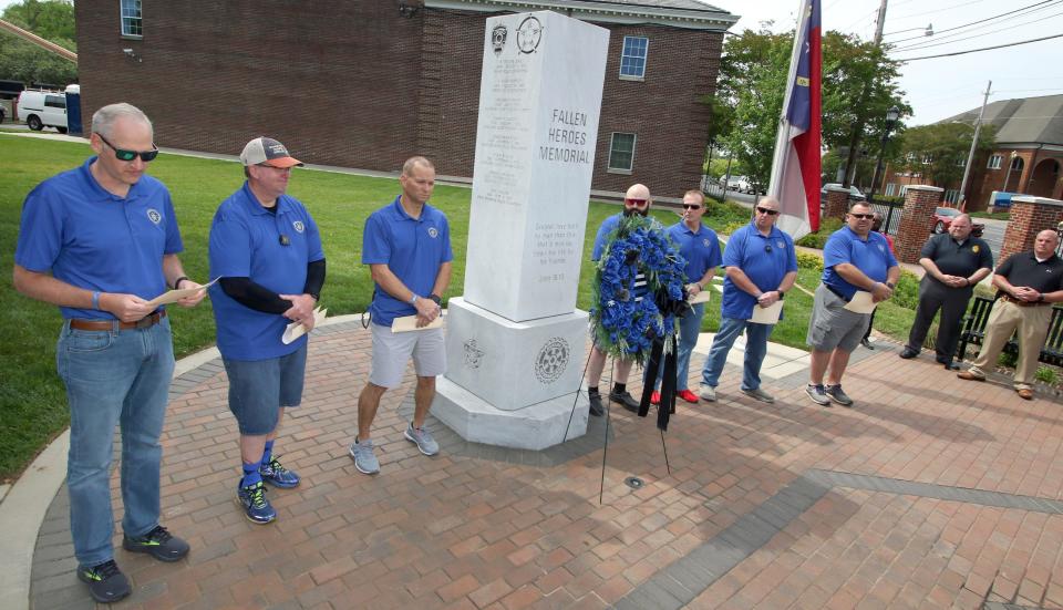 The names of fallen officers are read aloud during a wreath laying ceremony held Friday morning, May 5, 2023, at the Fallen Heroes Memorial in Shelby.