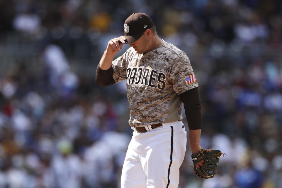 San Diego Padres' Craig Stammen pulls down his cap after giving up a grand slam to Los Angeles Dodgers' Justin Turner in the seventh inning of a baseball game Sunday, Sept. 11, 2022, in San Diego. (AP Photo/Derrick Tuskan)