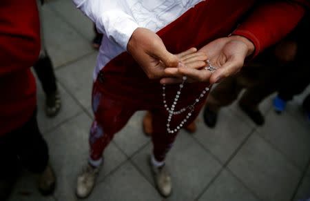 A man holds a rosary as he takes part in an anti-abortion demonstration in front of the Parliament in Warsaw, Poland September 22, 2016. REUTERS/Kacper Pempel