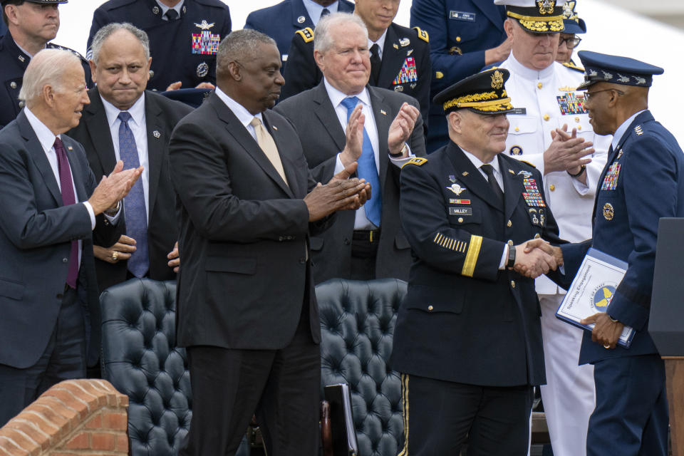 Incoming Joint Chiefs Chairman Gen. CQ Brown, Jr., right, shakes hands with outgoing Joint Chiefs Chairman Gen. Mark Milley, as President Joe Biden, left, and Secretary of Defense Lloyd Austin, look on during an Armed Forces Farewell Tribute in honor of Milley at Joint Base Myer–Henderson Hall, Friday, Sept. 29, 2023, in Fort Meyer, Va. Also held was an Armed Forces Hail in honor of Brown. (AP Photo/Alex Brandon)