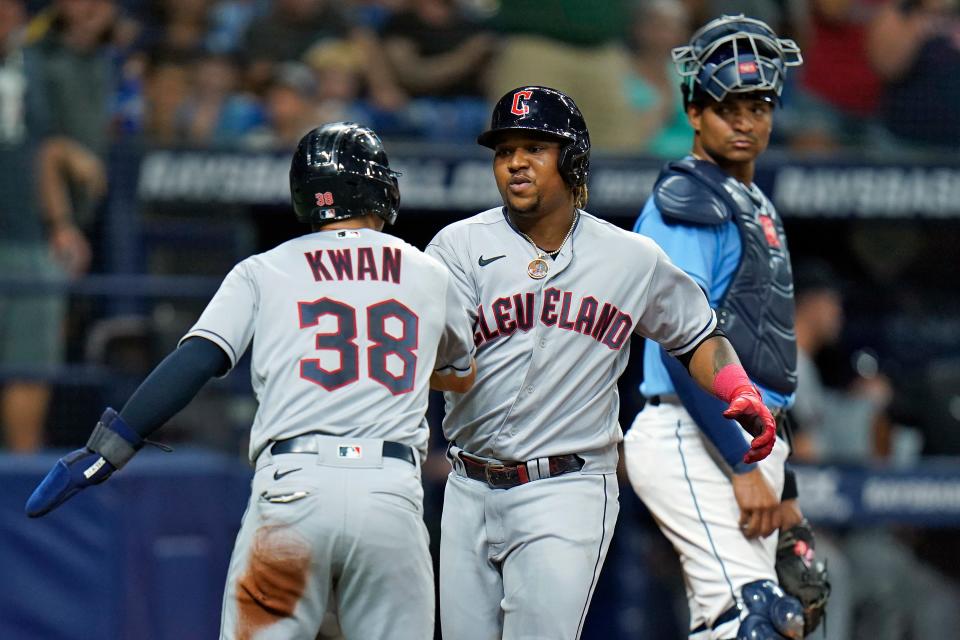 Cleveland Guardians' Jose Ramirez, center, celebrates his two-run home run off Tampa Bay Rays starting pitcher Jeffrey Springs with Steven Kwan, left, during the fifth inning of a baseball game Friday, July 29, 2022, in St. Petersburg, Fla. Looking on is Rays catcher Christian Bethancourt.