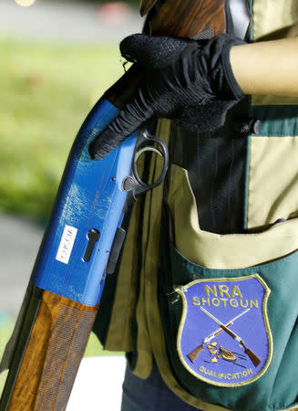 Sarah Cuccia, 17, holds her shotgun as she waits for her turn during a clay target youth group shooting meeting in Sunrise, Florida, U.S., February 26, 2018. Picture taken February 26, 2018. REUTERS/Joe Skipper