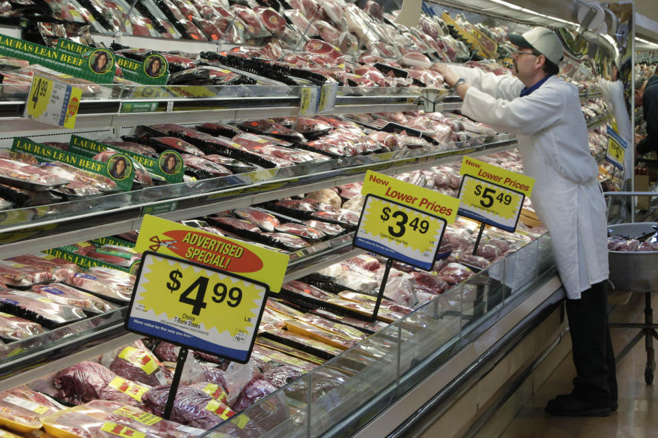 FILE - In this March 1, 2011, file photo, a worker stocks the fresh meat shelves at a Kroger Co. supermarket, in Cincinnati. The supermarket is one of the most important places to be shopping-savvy. The good news is that there are so many easy and effective way to slash your grocery budget. (AP Photo/Al Behrman, File)