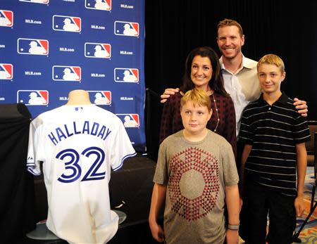 Roy Halladay is joined with his wife Brandy, sons Braden, right, and Ryan, center, before he announces his retirement at the MLB Winter Meetings at Walt Disney World Swan and Dolphin Resort. David Manning-USA TODAY Sports