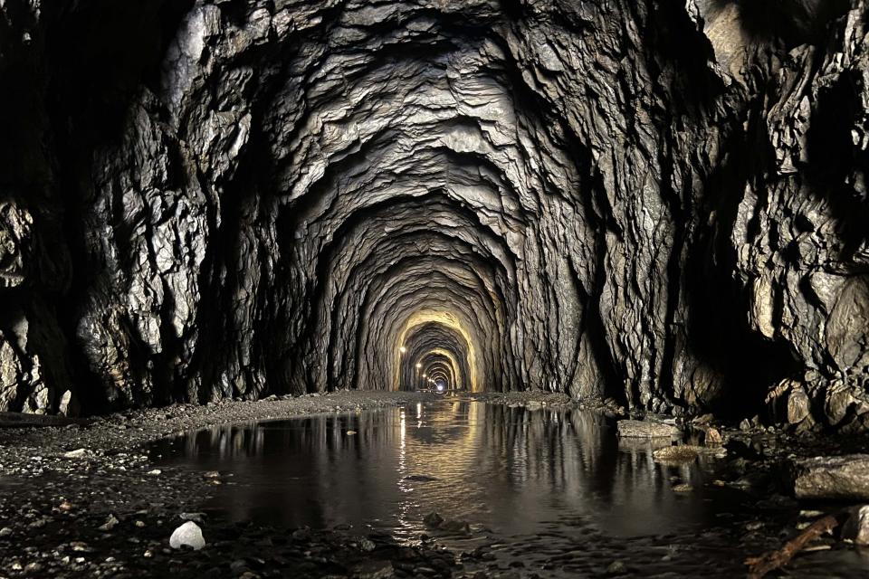 Water stands in a tunnel to the Aletsch Glacier near Goms, Switzerland, Wednesday, June 14, 2023. (AP Photo/Matthias Schrader)