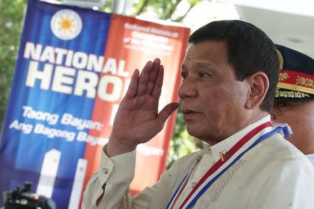 Philippine President Rodrigo Duterte salutes upon arrival at the National Heroes Day Commemoration at the Libingan ng mga Bayani in Fort Bonifacio, Taguig City, metro Manila, Philippines August 28, 2017. Malacanang Presidential Palace/Handout via Reuters/Files