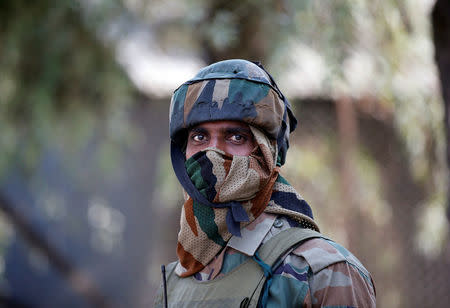 An Indian army soldier stands guard on a road on the outskirts of Srinagar, October 3, 2016. REUTERS/Danish Ismail