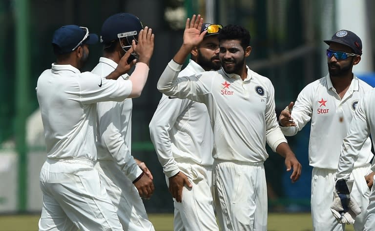 India's Ravindra Jadeja (2nd right) celebrates the wicket of New Zealand's Luke Ronchi with teammates during the fifth day of the first Test in Kanpur on September 26, 2016