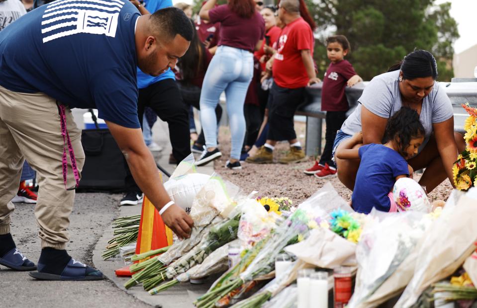 People leave flowers outside scene of shooting in El Paso, Texas on August 4, 2019.