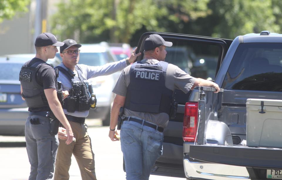 Police secure the scene where two police officers were wounded and a suspect was killed in an exchange of gunfire on Sunday, June 30, 2024, in Waterloo, Iowa. State investigators said Monday, July 1, 2024, said the police were responding to a report of a bicyclist with a gun. (Jeff Reinitz/The Courier via AP)