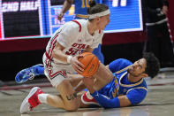 UCLA guard Johnny Juzang (3) and Utah guard Gabe Madsen (55) scramble for possession of the ball during the second half of an NCAA college basketball game Thursday, Jan. 20, 2022, in Salt Lake City. (AP Photo/Rick Bowmer)