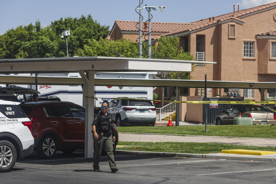 North Las Vegas Police investigate the scene of Monday night's shooting at an apartment complex in North Las Vegas, Tuesday, June 25, 2024. Authorities have arrested a man suspected in shootings Monday night at apartments outside of Las Vegas that left five people dead and a 13-year-old girl critically wounded. (Rachel Aston/Las Vegas Review-Journal via AP)