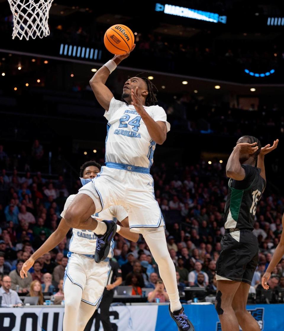 North Carolina’s Jae’Lyn Withers (24) breaks to the basket against Wagner’s Seck Zongo (15) in the first half on Thursday, March 21, 2024 during the NCAA Tournament at Spectrum Center in Charlotte, N.C.