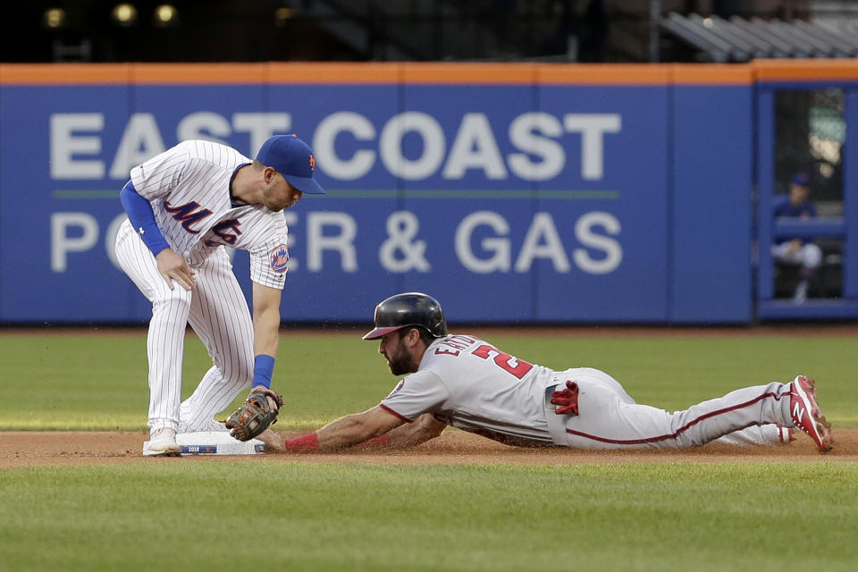 Washington Nationals' Adam Eaton, right, slides safely into second base against New York Mets second baseman Jeff McNeil during the first inning of a baseball game Saturday, Aug. 10, 2019, in New York. (AP Photo/Seth Wenig)