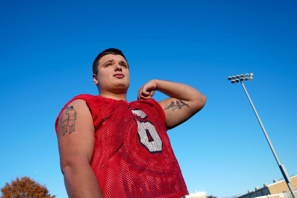 RJ Ussher, of the Westwood High School Football Team, is shown with his tattoo of him alongside his father on his right arm. Ussher also has a tattoo of three Cardinals on his left arm, representing his father and two others in his life who have died. Tuesday, November 14, 2023