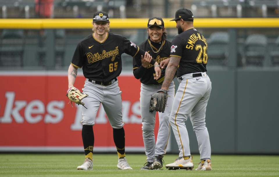 From left, Pittsburgh Pirates left fielder Jack Suwinski, center fielder Ji Hwan Bae and right fielder Canaan Smith-Njigba celebrate after the ninth inning of a baseball game against the Colorado Rockies Wednesday, April 19, 2023, in Denver. (AP Photo/David Zalubowski)