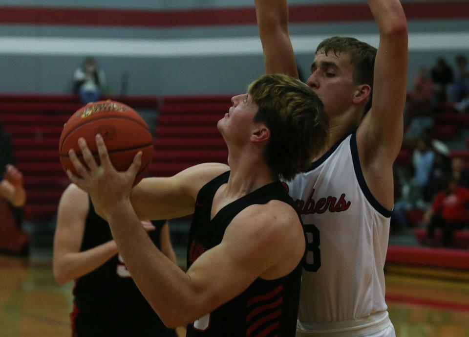 ADM's center Vince Benetti (23) looks for a shot around Ballard forward Nolan Cogdill (13)  during the second quarter at Ballard High School gym Friday, Dec. 2, 2022 in Huxley, Iowa. Photo by Nirmalendu Majumdar/Ames Tribune