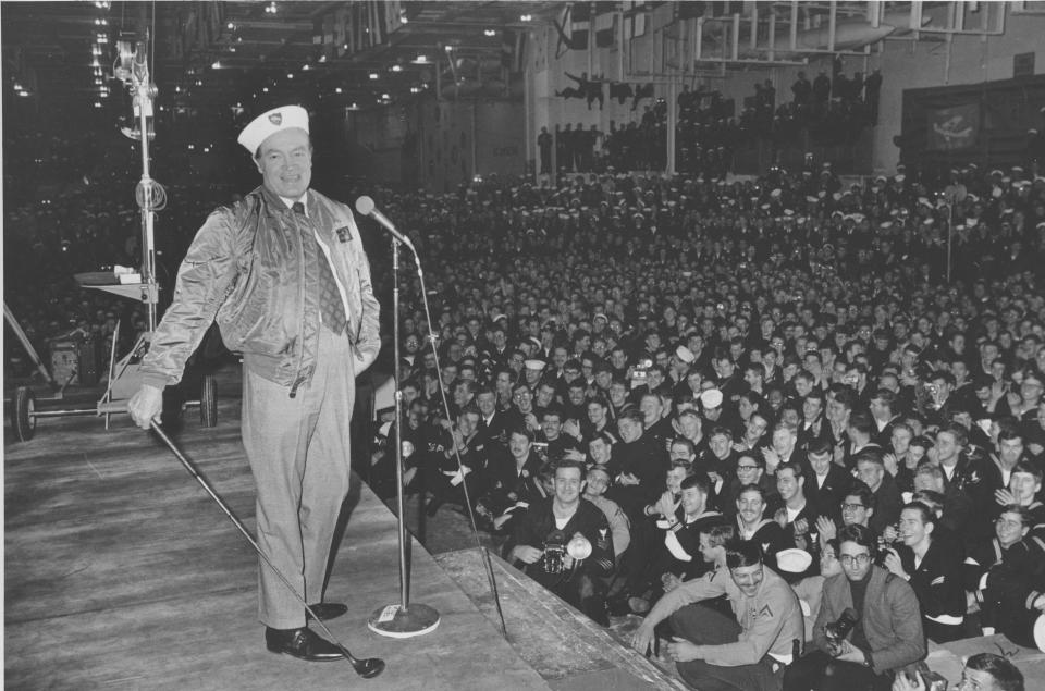 FILE - Comedian Bob Hope entertains sailors of the U.S. 6th Fleet Saratoga at the flagship's anchorage in the southern Italian port of Gaeta, in this Dec. 19, 1970 file photo. Hope is on his annual United Service Organizations (USO) tour to entertain Americans serving overseas. Hope, beloved actor and comedian, who died 10 years ago at age 100, is being celebrated at the National World War II Museum in New Orleans, where the World Golf Hall of Fame & Museum has brought the “Bob Hope: An American Treasure” traveling exhibition. The exhibit officially opens Saturday Aug. 3, 2013. (AP Photo, File)