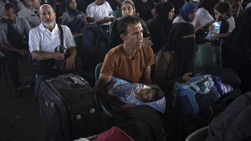 Palestinians wait to cross into Egypt at Rafah, Gaza Strip, on Wednesday, Nov. 1, 2023.