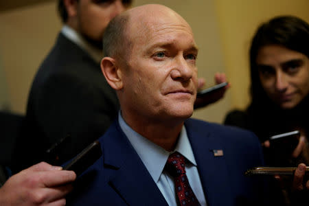 FILE PHOTO - Sen. Chris Coons (D-DE) speaks with reporters on the way to the Senate floor on Capitol Hill in Washington, U.S., October 3, 2018. REUTERS/Aaron P. Bernstein