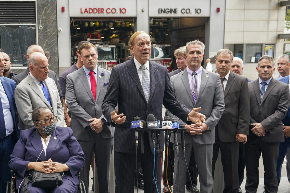 Retired NYPD Detective Barbara Burnette, foreground left, who worked on the World Trade Center pile for 23 days after the terrorist attacks in 2001 is joined by her attorney Nicholas Papain, background left, and former New York Gov. George Pataki, center, and other 9/11 first responders during a news conference, Wednesday, Sept. 8, 2021, in New York. Two decades after the collapse of the World Trade Center, people are still coming forward to report illnesses that might be related to toxic dust that billowed over the city after the terror attack.(AP Photo/Mary Altaffer)