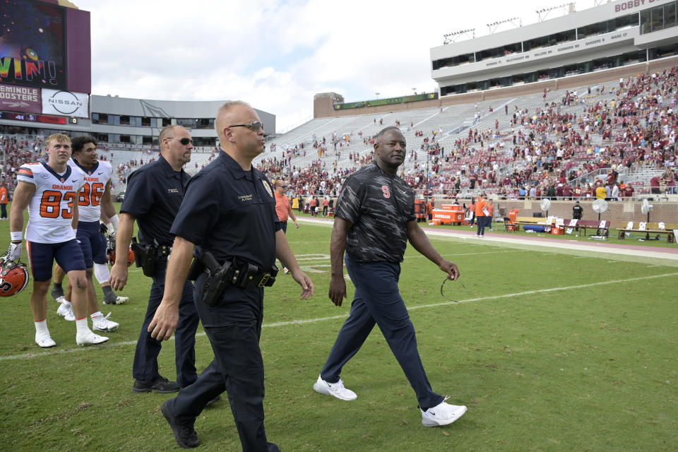 FILE - Syracuse head coach Dino Babers, right, leaves the field after a loss against Florida State during an NCAA college football game, Saturday, Oct. 14, 2023, in Tallahassee, Fla. Syracuse fired coach Dino Babers on Sunday, Nov. 19, after eight years with the Orange that included just two bowl appearances.(AP Photo/Phelan M. Ebenhack)