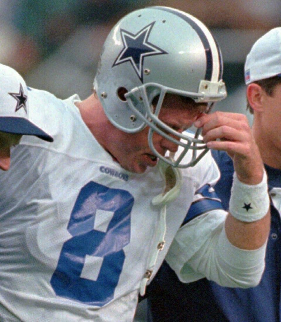 Dallas Cowboys quarterback Troy Aikman is escorted from the field after being injured while being sacked in 1997 in Philadelphia.