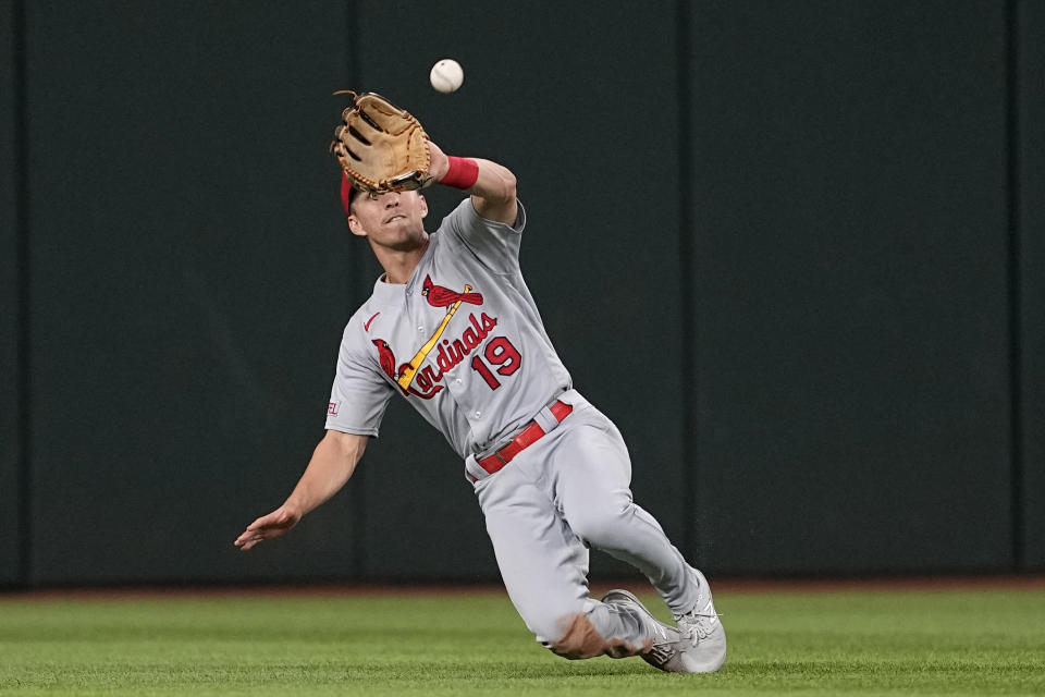 St. Louis Cardinals center fielder Tommy Edman makes a sliding catch of a fly ball by Texas Rangers' Marcus Semien during the sixth inning of a baseball game, Tuesday, June 6, 2023, in Arlington, Texas. (AP Photo/Tony Gutierrez)