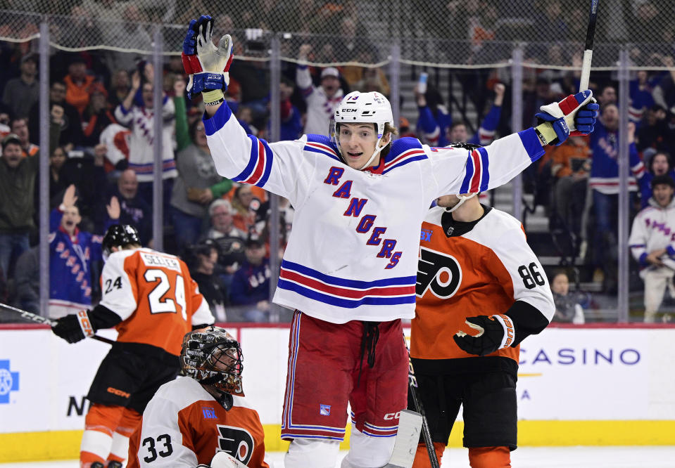 FILE - New York Rangers' Matt Rempe (73) celebrates after scoring past Philadelphia Flyers goaltender Samuel Ersson (33) during the third period of an NHL hockey game Feb. 24, 2024, in Philadelphia. Rempe fought seconds into his first NHL shift. Rangers fans chant his name whether he is playing or not. The 6-foot-8 forward was a central figure in a rare line brawl. And at 21 he has become a modern-day cult hockey hero. (AP Photo/Derik Hamilton, File)