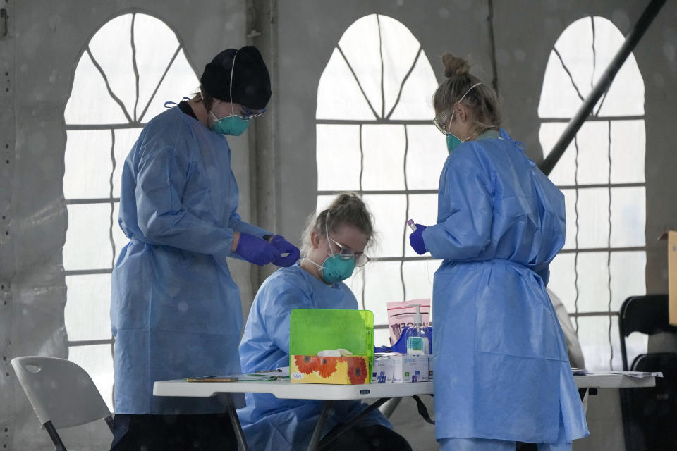 Staff prepare to take COVID-19 tests at a testing station in Nelson Bay, Australia, Monday, June 28, 2021. Australia was battling to contain several COVID-19 clusters around the country on Monday in what some experts have described as the nation’s most dangerous stage of the pandemic since the earliest days. (AP Photo/Mark Baker)